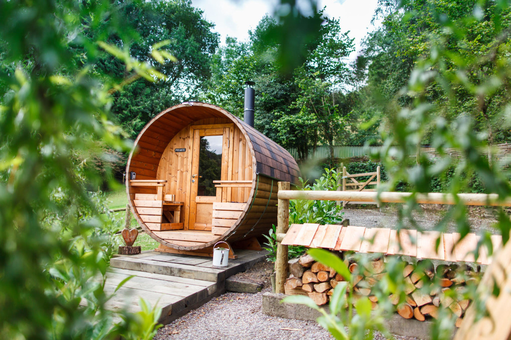 Wooden barrel sauna with terrace and wood fired heater 